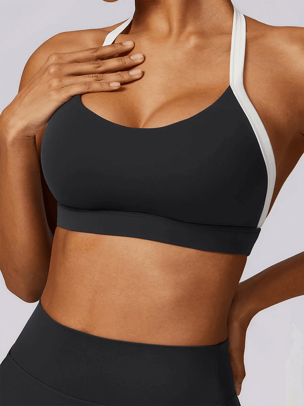 Woman wearing a black sleeveless yoga top from SF2374 set, designed for flexibility and breathability.